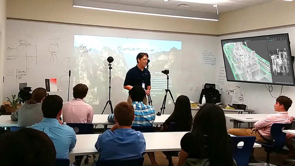 Christopher Hooper teaching digital media and creative technology concepts to students during a classroom lecture.